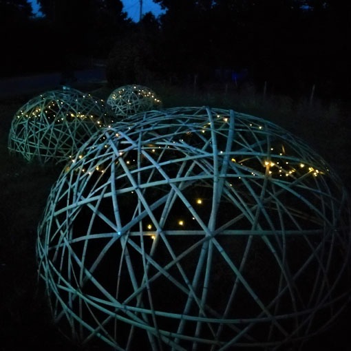 Dômes géodésiques en lamelles de bambous en pleine nuit.
